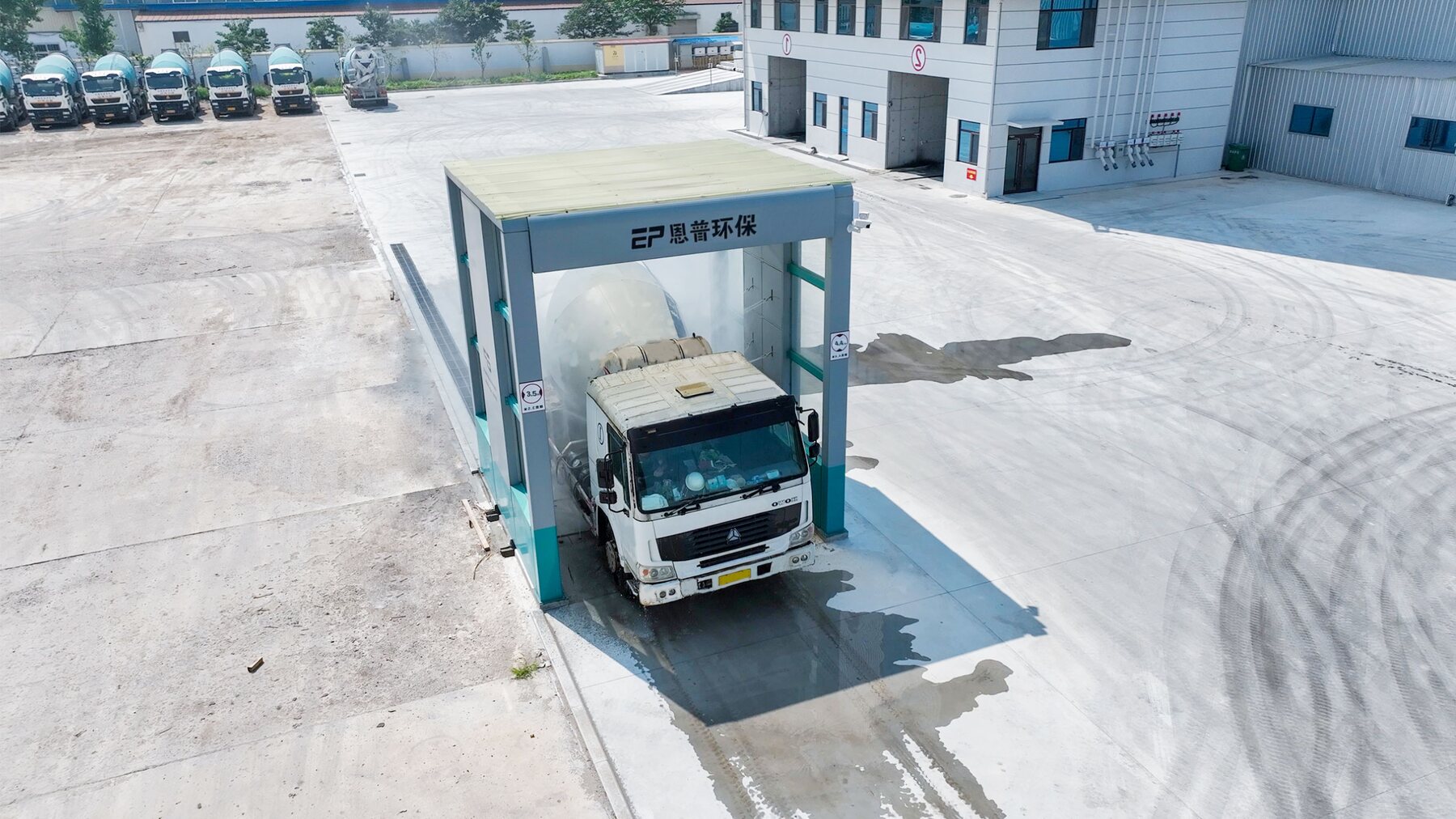 Mixer truck passing through an Enpu Construction Vehicle Wash System at the factory