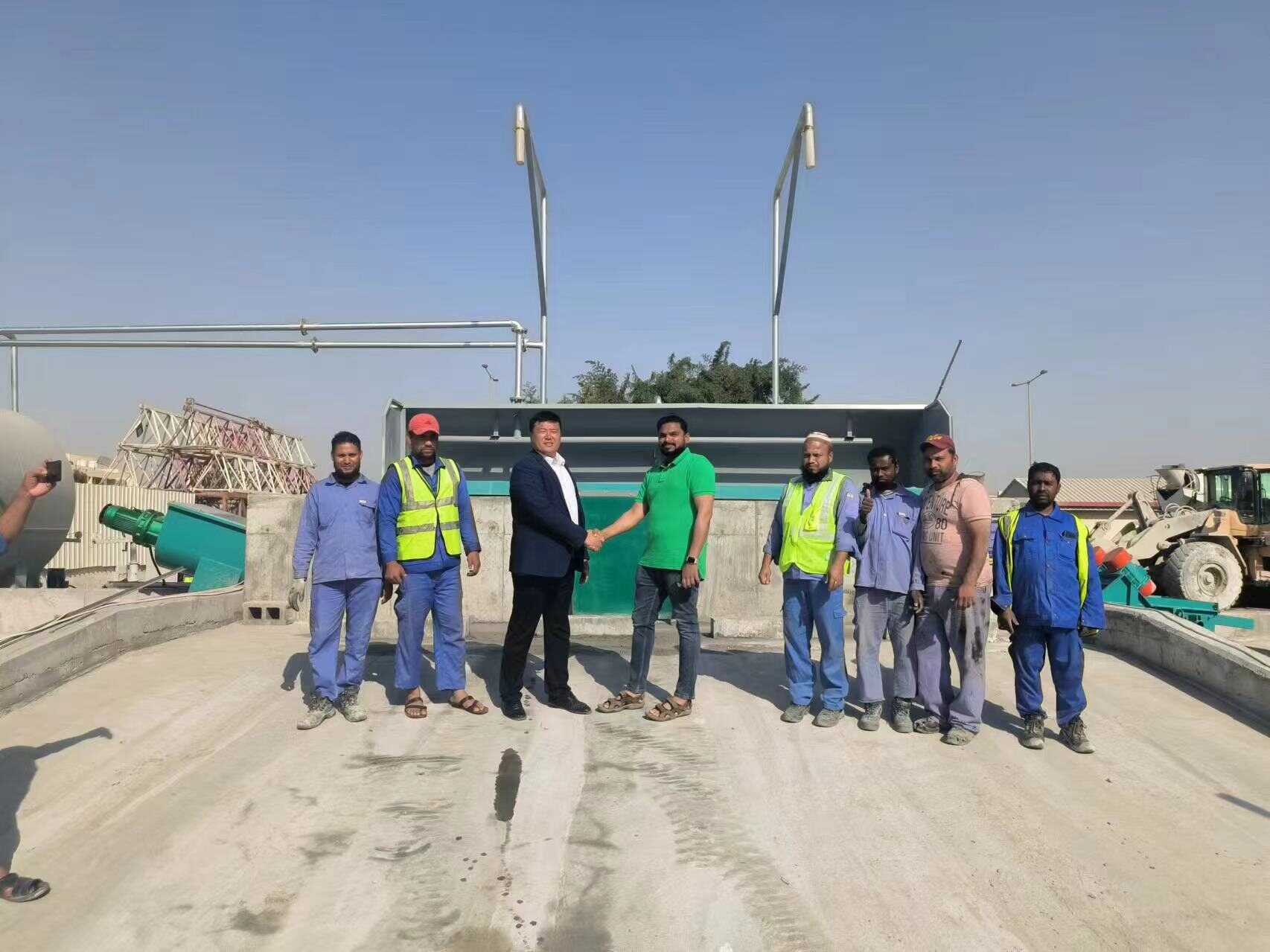 Enpu representatives and customer team beside installed concrete recycling equipment